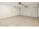 Clean, empty garage featuring a concrete floor, white walls, and a closed garage door at 4256 W Jeanette Ln, San Tan Valley, AZ 85144