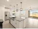Kitchen boasts stainless steel appliances, granite counters and an island with sink at 4256 W Jeanette Ln, San Tan Valley, AZ 85144