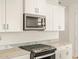 Close up of stainless steel appliances, white cabinets, and granite countertops at 4256 W Jeanette Ln, San Tan Valley, AZ 85144