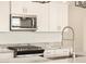 Close up of stainless steel appliances, white cabinets, and granite countertops at 4256 W Jeanette Ln, San Tan Valley, AZ 85144