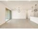 Bright living room features sliding glass door, and modern light fixtures, great for entertaining at 4256 W Jeanette Ln, San Tan Valley, AZ 85144