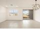 Spacious living room features tile flooring, modern lighting, and a large window at 4256 W Jeanette Ln, San Tan Valley, AZ 85144