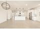 Spacious living room showcasing an open floor plan, tile flooring, and a modern kitchen with white cabinets at 4256 W Jeanette Ln, San Tan Valley, AZ 85144