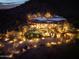 Stunning night view of an estate home with a pool and illuminated landscaping and mountain views at 8300 E Dixileta Dr # 263, Scottsdale, AZ 85266