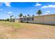 View of the backyard showing the home's exterior and desert landscaping with blue sky at 11038 W Windsor Dr, Sun City, AZ 85351