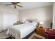 Cozy bedroom features a ceiling fan, neutral walls, and a comfortable bed at 11038 W Windsor Dr, Sun City, AZ 85351