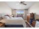 Bright bedroom with natural light, a ceiling fan, and ample storage at 11038 W Windsor Dr, Sun City, AZ 85351