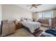 Bright bedroom with neutral walls, cozy carpeting, and a comfortable bed with side tables at 11038 W Windsor Dr, Sun City, AZ 85351