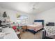 Bedroom with a ceiling fan and a window overlooking the yard at 11038 W Windsor Dr, Sun City, AZ 85351