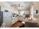 Cozy kitchen with white cabinets, vintage appliances, wood-look flooring, and ample natural light at 11038 W Windsor Dr, Sun City, AZ 85351