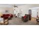 Inviting living room featuring plush carpeting, ceiling fan and comfortable furnishings at 11038 W Windsor Dr, Sun City, AZ 85351