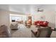 Spacious living room with plush carpet, ceiling fan, and lots of natural light at 11038 W Windsor Dr, Sun City, AZ 85351