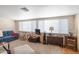 Comfortable living room filled with natural light and a blue sofa at 11038 W Windsor Dr, Sun City, AZ 85351