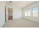 Bright bedroom with plush carpet, neutral walls, and ample natural light from multiple windows at 4780 W Flat Iron Ct, Queen Creek, AZ 85144