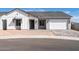 Charming single-story home featuring a modern design with stone accents and a two-car garage at 4780 W Flat Iron Ct, Queen Creek, AZ 85144