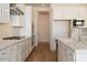 Modern kitchen design with stainless steel appliances, sleek white cabinets, and marble-look backsplash at 4780 W Flat Iron Ct, Queen Creek, AZ 85144