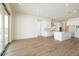Bright living room with wood-look tile floors, recessed lighting, and sliding glass doors at 4780 W Flat Iron Ct, Queen Creek, AZ 85144