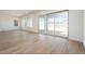 Spacious living room with wood-look tile flooring and sliding glass doors to the outdoor patio at 4780 W Flat Iron Ct, Queen Creek, AZ 85144