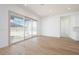 Bright living room featuring wood-look tile flooring, large sliding glass doors, and access to patio at 4780 W Flat Iron Ct, Queen Creek, AZ 85144
