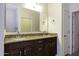 Bathroom featuring double sinks, granite countertops, and framed mirror at 846 N Pueblo Dr # 110, Casa Grande, AZ 85122