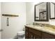Bathroom featuring granite countertop, a sink, dark wood cabinets, and a decorative mirror at 846 N Pueblo Dr # 110, Casa Grande, AZ 85122