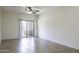 A bedroom with tile floors and sliding glass doors leading to a balcony at 846 N Pueblo Dr # 110, Casa Grande, AZ 85122