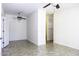 Empty bedroom showing tile flooring, ceiling fan, and multiple doorways at 846 N Pueblo Dr # 110, Casa Grande, AZ 85122