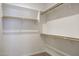 Walk-in closet offering ample storage space with wooden rods and shelves for organization at 846 N Pueblo Dr # 110, Casa Grande, AZ 85122