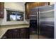 Kitchen features stainless steel refrigerator and granite countertops by the window at 846 N Pueblo Dr # 110, Casa Grande, AZ 85122