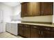Laundry room with granite counters, cabinets, shelving, and appliances at 846 N Pueblo Dr # 110, Casa Grande, AZ 85122