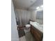 A clean bathroom features a single sink vanity, shower and tub, and a ceramic tile backsplash at 4330 W Mescal St, Glendale, AZ 85304