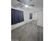 This bedroom has modern vinyl floors, a ceiling fan, and mirrored closet doors at 4330 W Mescal St, Glendale, AZ 85304
