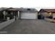 Exterior shot of a home featuring a wide driveway and solar panels at 4330 W Mescal St, Glendale, AZ 85304