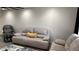 This living room features modern flooring and a comfortable gray sofa with a decorative pillow at 4330 W Mescal St, Glendale, AZ 85304