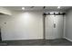This living room features barn doors, recessed lights and sleek, modern flooring at 4330 W Mescal St, Glendale, AZ 85304