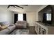 A bright living room featuring gray sofas, modern flooring, and a large screen TV at 4330 W Mescal St, Glendale, AZ 85304