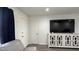 A bright living room featuring gray sofas, modern flooring, and a large screen TV at 4330 W Mescal St, Glendale, AZ 85304