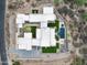 A bird's eye view reveals a unique modern property with pool, patio, and pristine landscaping at 8386 E Leaning Rock Rd, Scottsdale, AZ 85266