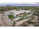 Aerial view of an estate home featuring a pool, spa, outdoor kitchen, and desert landscaping at 8386 E Leaning Rock Rd, Scottsdale, AZ 85266