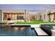 Stunning backyard features a modern pool, lush artificial turf, and a sleek, contemporary home design at 8386 E Leaning Rock Rd, Scottsdale, AZ 85266
