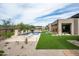 A modern home with a manicured backyard, pool, spa, artificial turf and desert landscaping at 8386 E Leaning Rock Rd, Scottsdale, AZ 85266