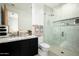Modern bathroom featuring a glass-enclosed shower, dual vanity with marble countertop, and sleek fixtures at 8386 E Leaning Rock Rd, Scottsdale, AZ 85266