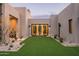 Inviting courtyard with manicured artificial turf, desert landscaping, and sleek modern architecture at 8386 E Leaning Rock Rd, Scottsdale, AZ 85266