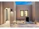 Stunning courtyard with travertine flooring, accent lighting, desert landscaping, and modern water feature at 8386 E Leaning Rock Rd, Scottsdale, AZ 85266