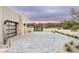 Elegant driveway with stone accents, desert landscaping, and stunning mountain views at sunset at 8386 E Leaning Rock Rd, Scottsdale, AZ 85266
