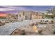 Paver driveway with desert landscaping leading to a modern home with stone accents and garage door at 8386 E Leaning Rock Rd, Scottsdale, AZ 85266