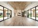 Open-concept living room boasts wood ceiling, a marble fireplace, and glass doors on each side at 8386 E Leaning Rock Rd, Scottsdale, AZ 85266