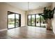 Open-plan living area with hardwood floors, modern light fixture, and access to the backyard at 8386 E Leaning Rock Rd, Scottsdale, AZ 85266