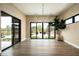 Bright living room with hardwood floors, modern lighting, and backyard views at 8386 E Leaning Rock Rd, Scottsdale, AZ 85266