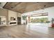 Bright open living area with wood-planked ceilings, marble fireplace, and sliding doors to the pool at 8386 E Leaning Rock Rd, Scottsdale, AZ 85266